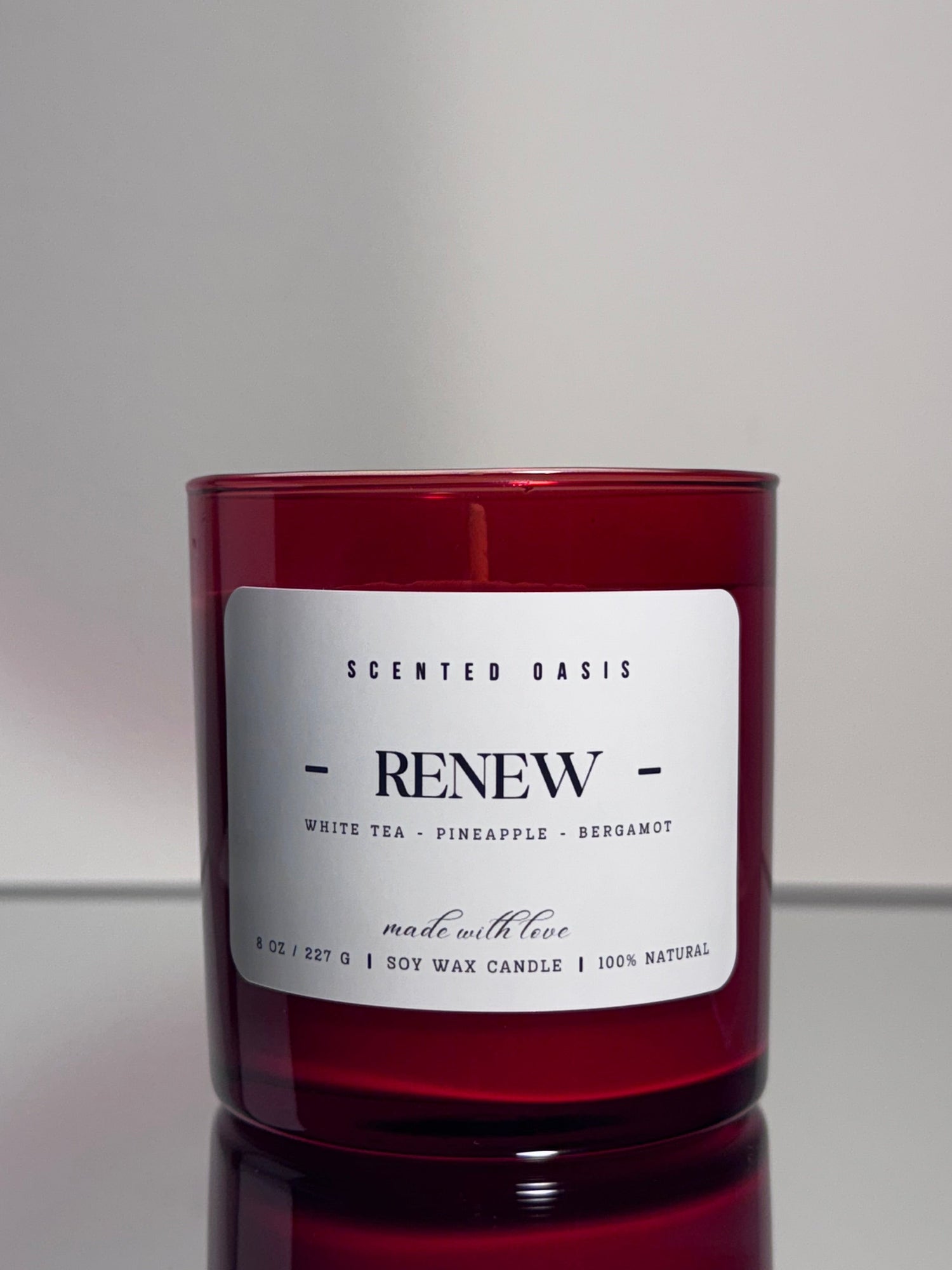 Red cylindrical container with a white label on a gray background